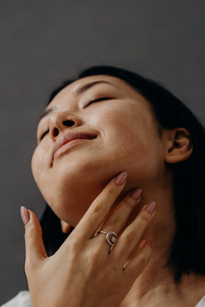 pexels photo 6543620 Woman enjoying a facial massage with closed eyes and relaxed expression, promoting self-care and wellness.